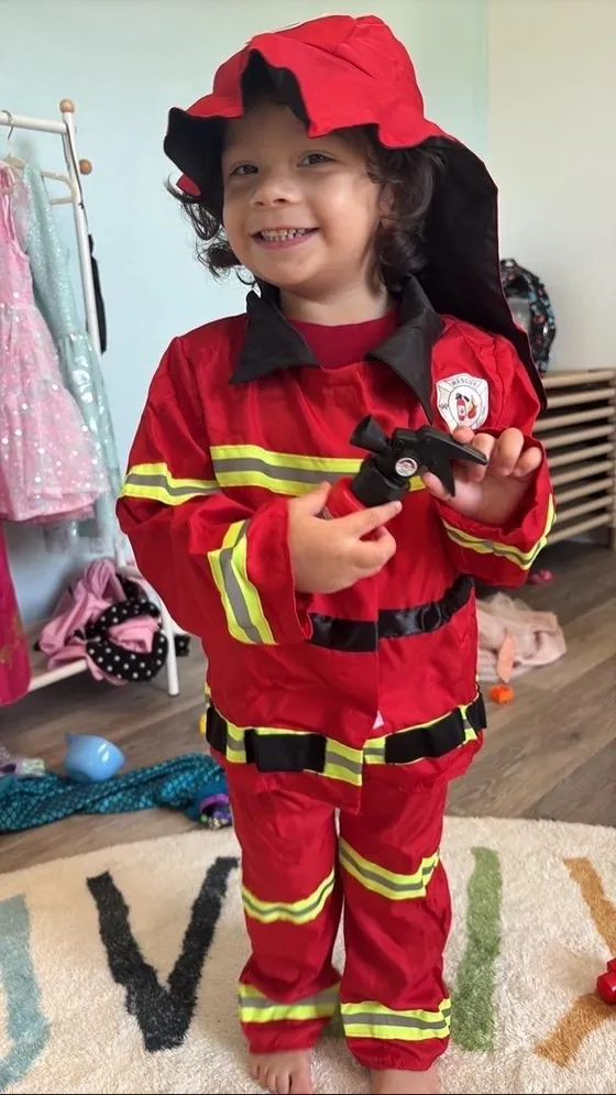 A child dressed up as a firefighter during play at Bright Haven