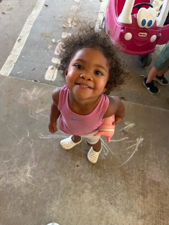 A smiling child playing outside at Bright Haven