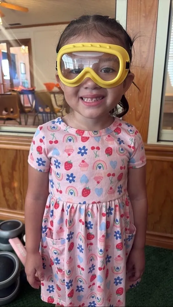 A smiling child wearing play goggles at Bright Haven