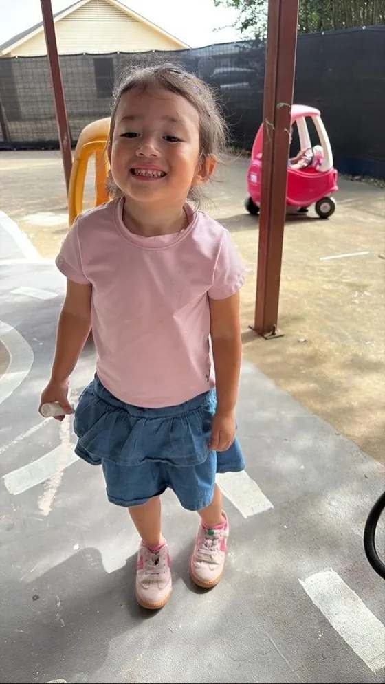 A smiling child playing outside at Bright Haven