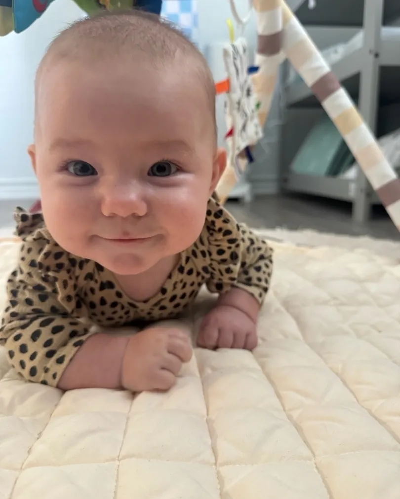 A baby during tummy time at Bright Haven