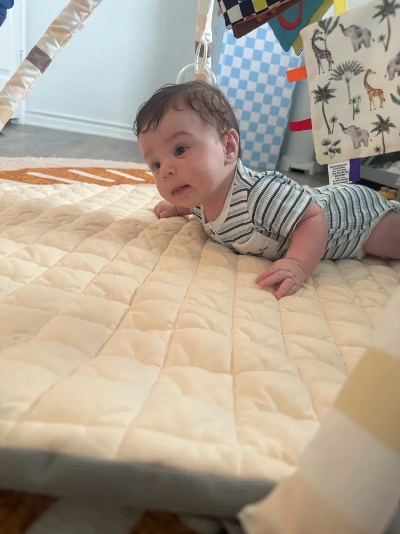 A baby during tummy time at Bright Haven