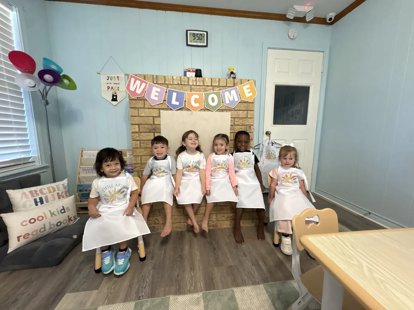 Pre-K children in Little Artist aprons at Bright Haven